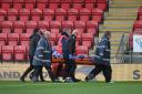 Callum Guy is stretchered off at Orient
