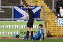 Referee Thomas Reeves beckons Carlisle's physios with Jack Robinson down injured