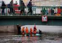 Emergency responders work to recover victims of the bus crash in St Petersburg (Dmitri Lovetsky/PA)