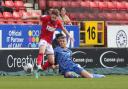 Sam Lavelle challenges Alfie May - before the defender's error let in the striker for the winner
