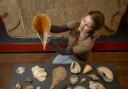 Dr Frances McIntosh, English Heritage’s collections curator for Hadrian’s Wall and the North East, with a collection of shells