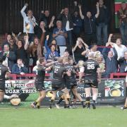 HAT-TRICK HERO: Sam Forrester celebrates one of his three tries with team-mates and fans                       Charlie Perry