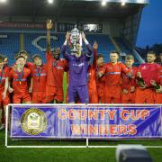 Workington Reds captain Danny Eccles lifts the Fred Conway Cumberland Cup after their 9-1 win over Penrith at Brunton Park