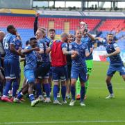 Carlisle celebrate their memorable win at Bolton in October