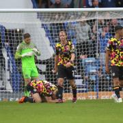 Carlisle's players are crestfallen after Portsmouth's late goal