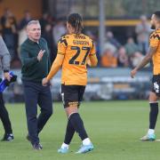Paul Simpson shakes hands with Cambridge's ex-Blues striker JK Gordon after the game