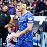 Sam Lavelle and a young Cambridge fan wearing noise-cancelling headphones before Saturday's game
