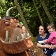 Claire Steel and Savannah Carruthers look at Forestry England's statue on its Gruffalo Trail