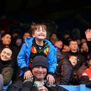 A young fan enjoys his day at Brunton Park for the Stevenage game