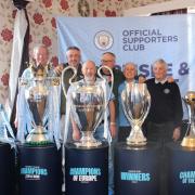 Local Manchester City fans get their picture taken with the silverware at Carlisle Conservative Club