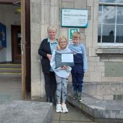 Louise Robertson, alongside  Holly and Ted, outside Kendal's County Hall