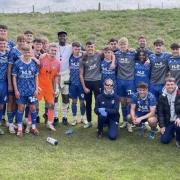 Usain Bolt poses with the Carlisle under-18 side at Creighton