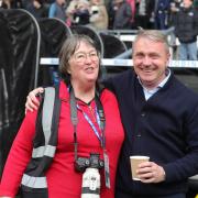 Barbara Abbott, pictured with Paul Simpson at Carlisle's game at Derby on Saturday, is retiring after many seasons photographing the Blues