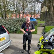 A member of the Blood Bikes team enjoys cake at the coffee morning