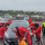 Volunteers wash the vehicles