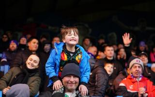 A young fan enjoys his day at Brunton Park for the Stevenage game