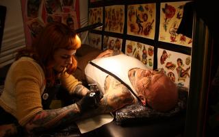 Colin Fell, 64, who put on the event, being tattooed by daughter Megan Hubbard, 33, of So True Tattooing in Peterborough