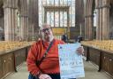 Artist JYMA holding the poster for Faith, Art & Me, due to be displayed in Carlisle Cathedral in May Half Term 2024