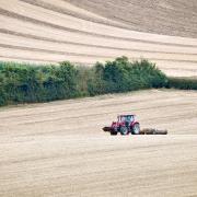 A tractor in a farmed landscape (Ben Birchall/PA)