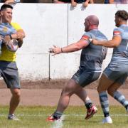We've done it: Whitehaven player-coach Carl Forster, second right, celebrates the 24-22 win over Workington Town with his team-mates (Photos: Ben Challis)