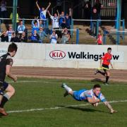 Scott Rooke flies over to score against All Golds
