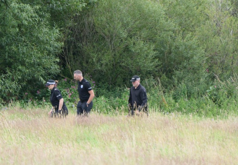 Investigation: Police look for clues following the death of Lee McKnight