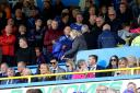 The Piataks, pictured in the directors' box during September's game against Derby, are poised to begin a new era at Brunton Park