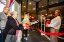 Lorraine Miles was chosen as the first customer to cut the ribbon