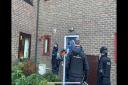 Police conducting a drugs warrant