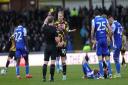Referee Thomas Parsons books Luke Armstrong during the defeat at Bristol Rovers