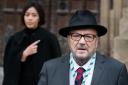 George Galloway, with his wife Putri Gayatri Pertiwi, speaks to the media outside the Houses of Parliament in Westminster