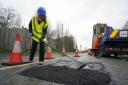 Esther McVey helps repair potholes in Leigh in Greater Manchester (Peter Byrne/PA)