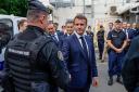 The French president visited the central police station in Noumea, New Caledonia, during his visit (Ludovic Marin/AP)