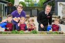 The Old Station Nursery children planting their seeds alongside Stuart Locke (right), Bewley Homes sales manager