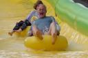 Liberal Democrat leader Sir Ed Davey rides down the Ultimate Slip n Slide attraction near Frome, Somerset, while on the General Election campaign trail. Picture date: Thursday May 30, 2024. PA Photo. See PA story POLITICS Election LibDems. Photo credit