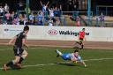 Scott Rooke flies over to score against All Golds
