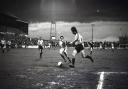 Future Blues No2 Dennis Booth, left, looks on as Watford clear their lines at Brunton Park