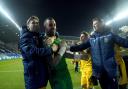 Dean Bouzanis, second left, is mobbed after his penalty shoot-out heroics for Sutton at Wigan (photo: PA)