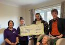 Hardwicke Circus members (two on the right) presenting a fundraising cheque to Ann (bottom of the image).