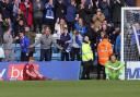 Gillingham fans roar their joy as Morgan Feeney and Tomas Holy look dejected after the home side's winner