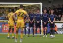 Carlisle players line up in a defensive wall at Sutton
