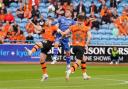 Carlisle's Alfie McCalmont jumps between two Dundee United opponents