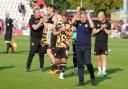 Paul Simpson and his staff and players acknowledge United's fans at Stevenage