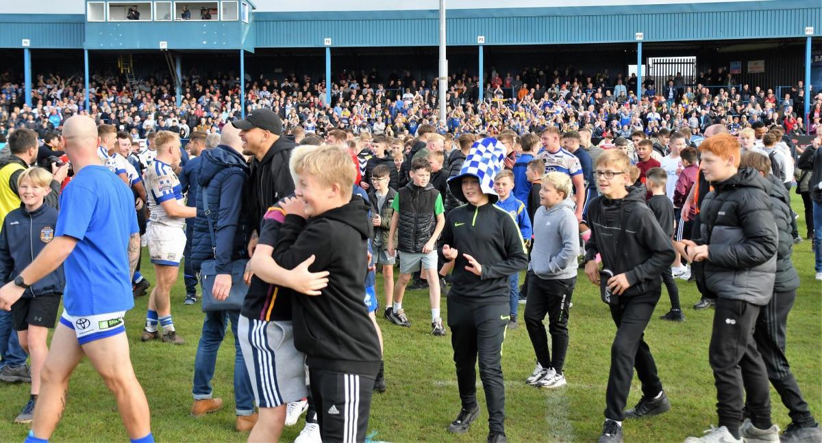 JOY: Workington supporters mob the team at the end of the game (Ben Challis)