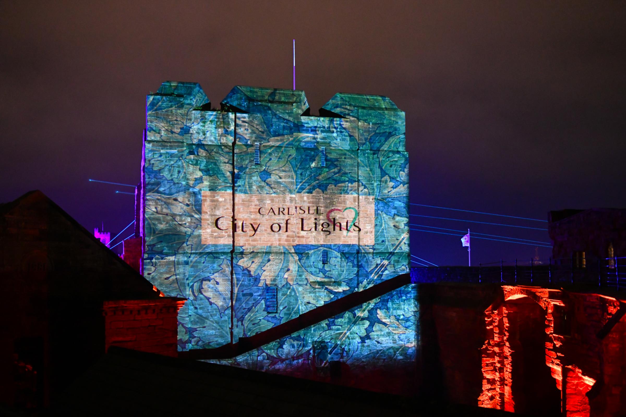 Carlisle City of Light Festival 2021. The three day festival in the historic quarter of Carlisle. Son et lumière projections were beamed onto the Fratry at Carlisle Cathedral and the Keep of Carlisle Castle. Visitors followed at trail through