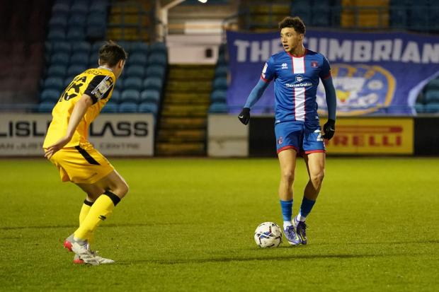 News and Star: Jordan Gibson takes on the Lincoln defence