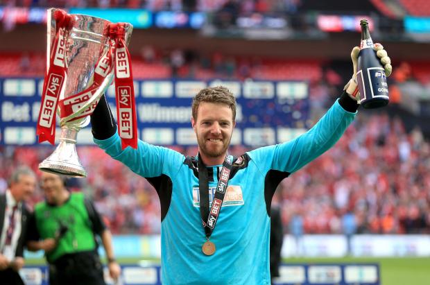 News and Star: Collin celebrates promotion with Rotherham after his penalty shoot-out saves against Leyton Orient in 2014's play-off final (photo: PA)