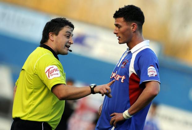 News and Star: Ref Paul Evans has words with United's Gary Madine