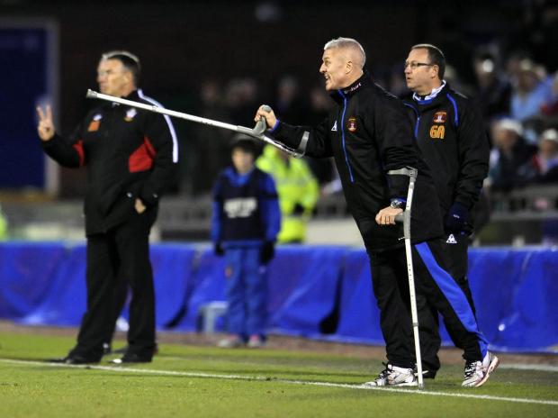 News and Star: Assistant boss Graham Kavanagh, on crutches after an operation, shouts instructions