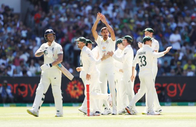 Ben Stokes, left, walks off after being dismissed by Mitchell Starc (photo: PA)